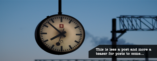 a hanging analog clock with a caption saying"this is less a post and more a teaser for posts to come"